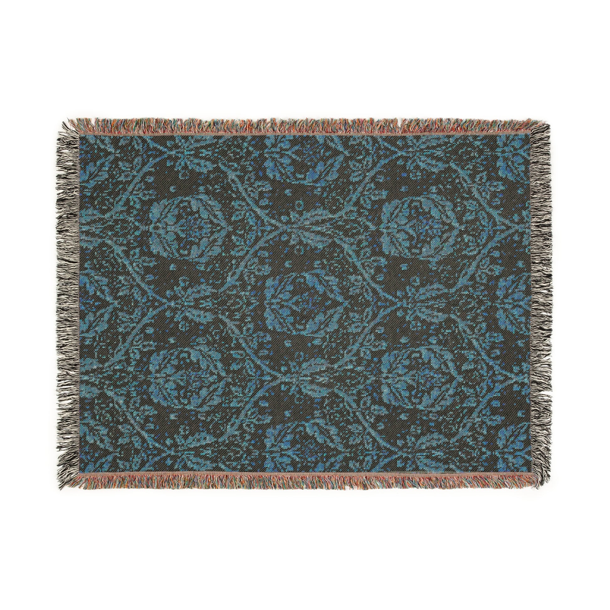 A woven cotton blanket with a geometric Willy Morris & Co pattern in beige, brown, and multicolour, with fringed edges.