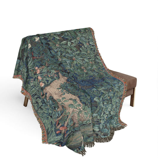 Decorative blanket with nature-themed design draped over a chair on a white background