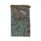 Decorative throw blanket with leaf pattern and fringes on a white background