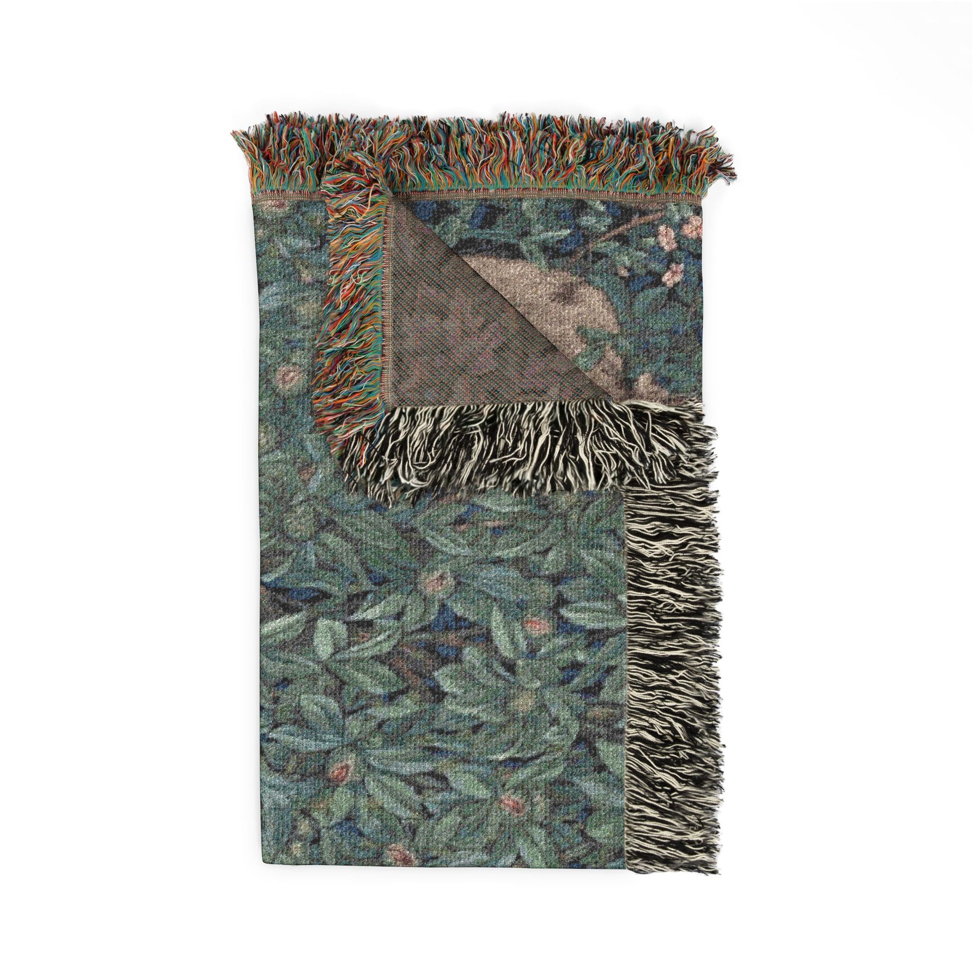 Woven blanket with leaf pattern and fringed edges on a white background