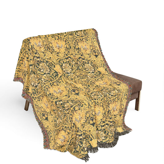 Decorative yellow and black patterned throw blanket on a chair with a white background