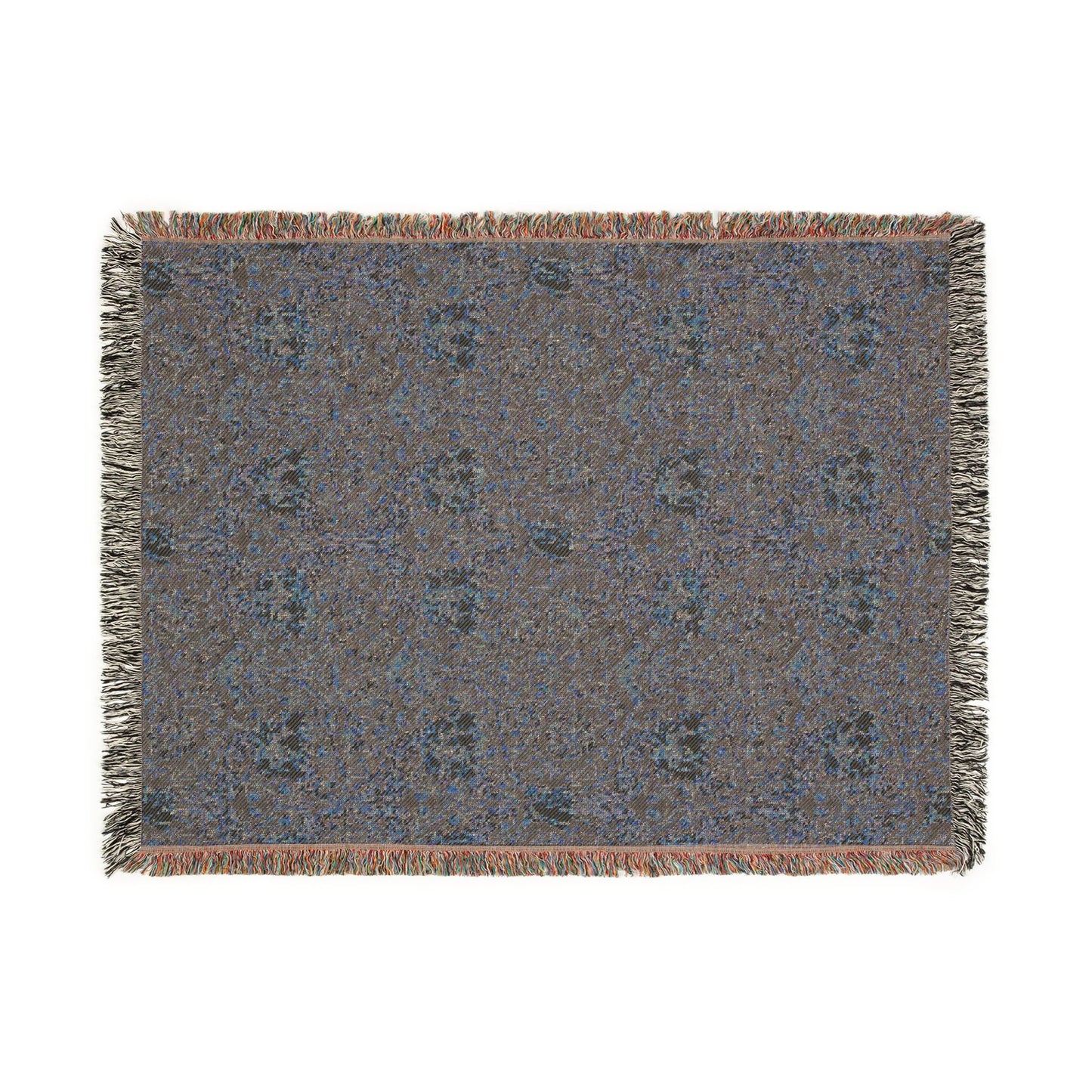 Textile with a floral pattern and fringe on a white background