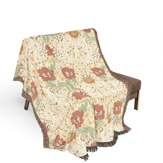 Floral patterned throw blanket draped over a chair on a white background