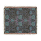 Floral patterned throw blanket with fringe on a white background