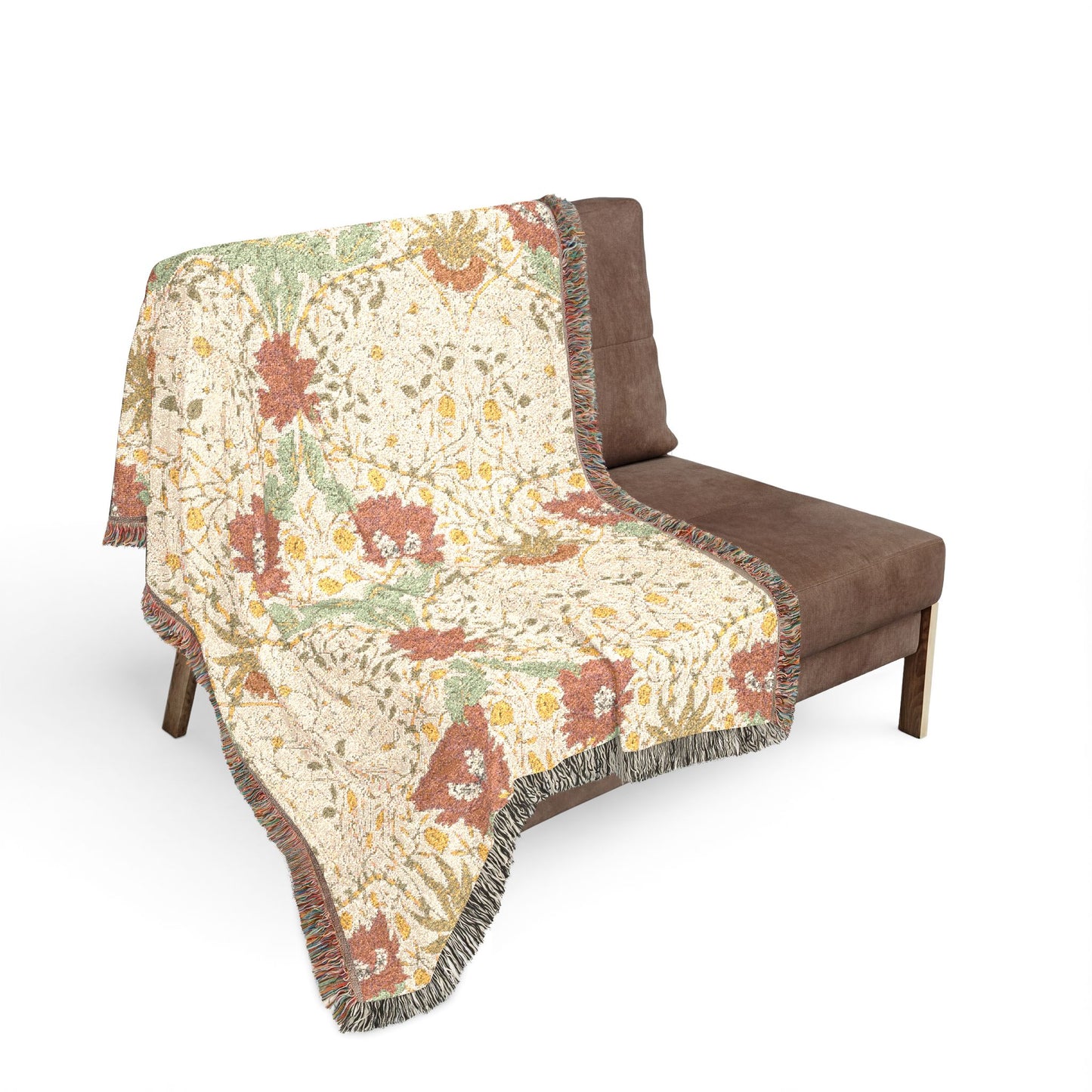 Floral patterned throw blanket draped over a brown chair on a white background