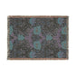 Floral patterned throw blanket with fringe on a white background