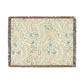 Floral patterned throw blanket with fringe on a white background