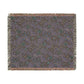 Patterned throw blanket with fringe on a white background
