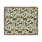 Floral patterned throw blanket with fringe on a white background