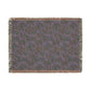 Patterned throw blanket with fringe on a white background