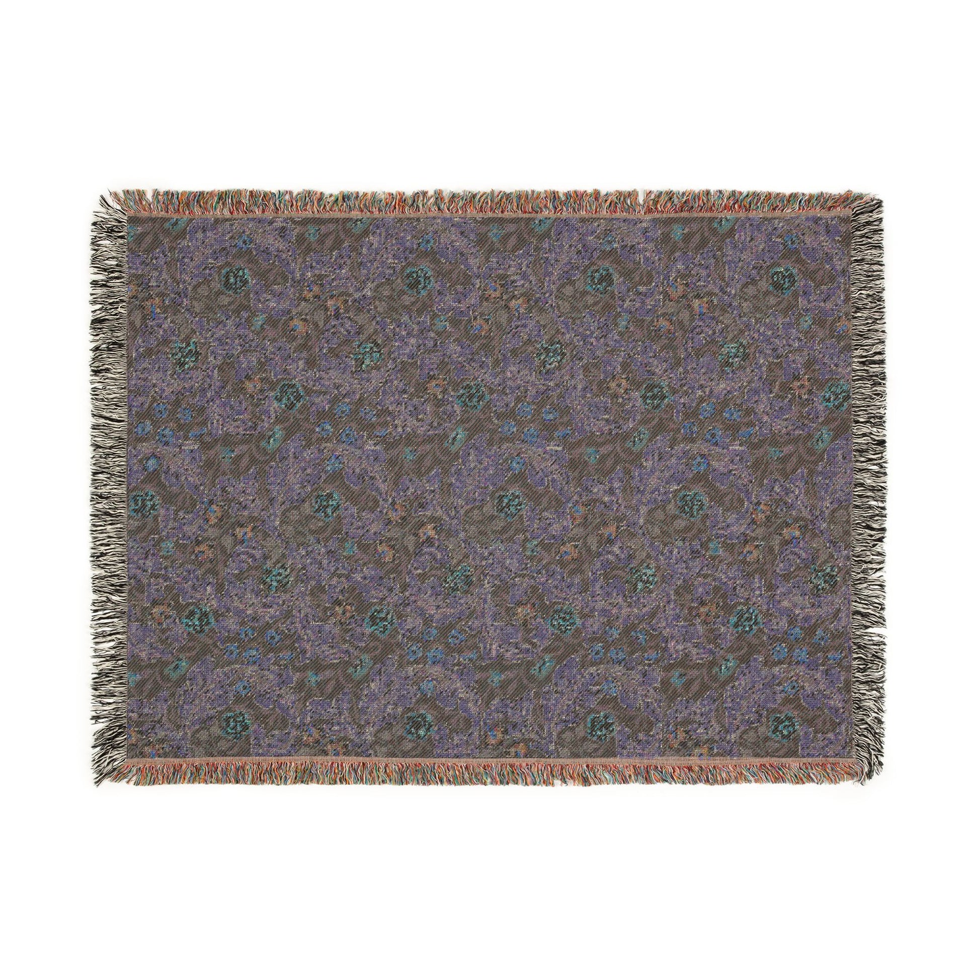 Patterned throw blanket with fringe on a white background