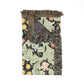 Floral patterned throw blanket with fringes on a white background