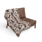 Brown patterned throw blanket draped over a brown chair on a white background