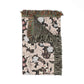 Floral patterned throw blanket with fringes on a white background