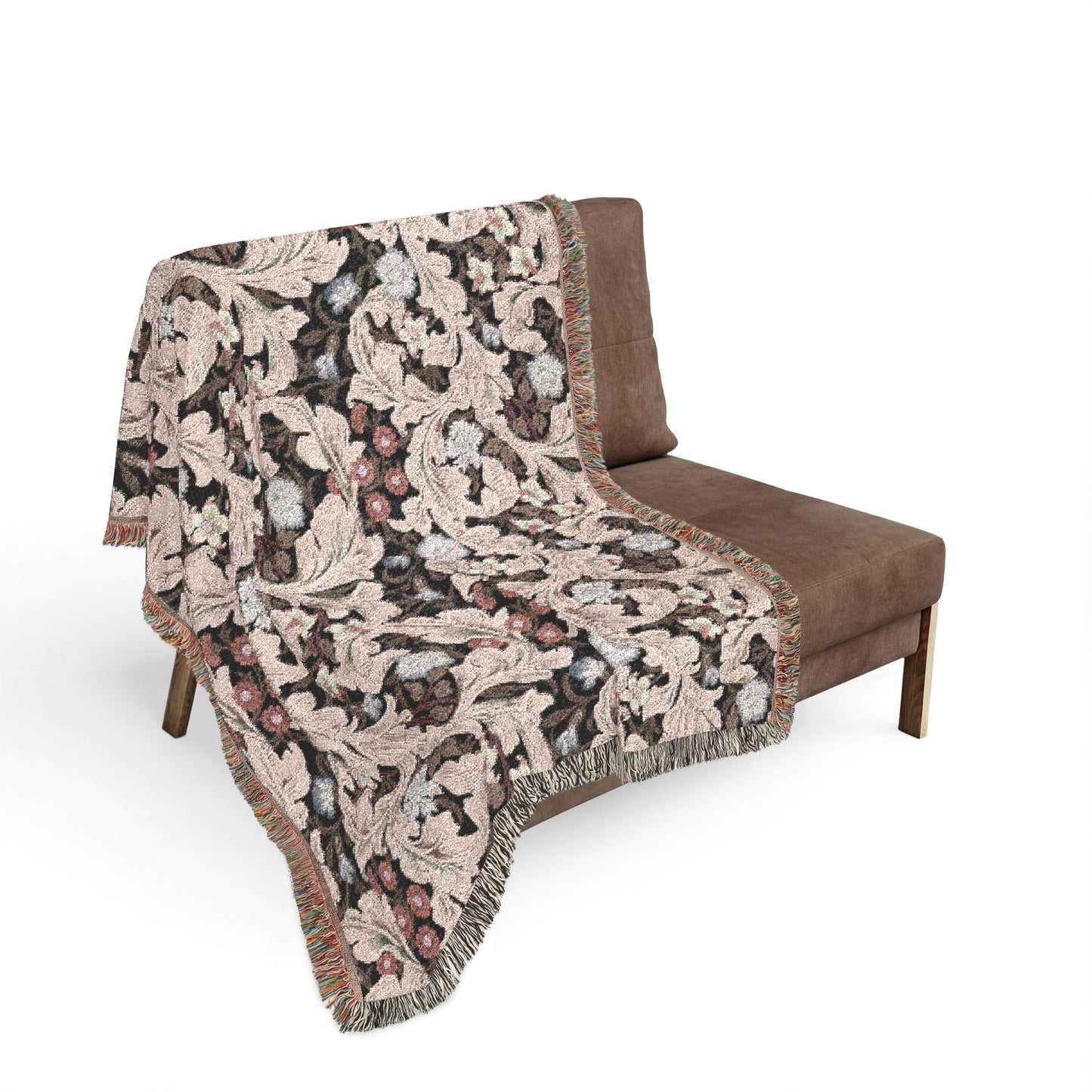 Floral patterned throw blanket draped over a brown chair on a white background
