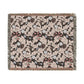 Decorative throw blanket with intricate floral pattern on a white background