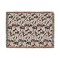 Decorative throw blanket with intricate floral pattern on a white background