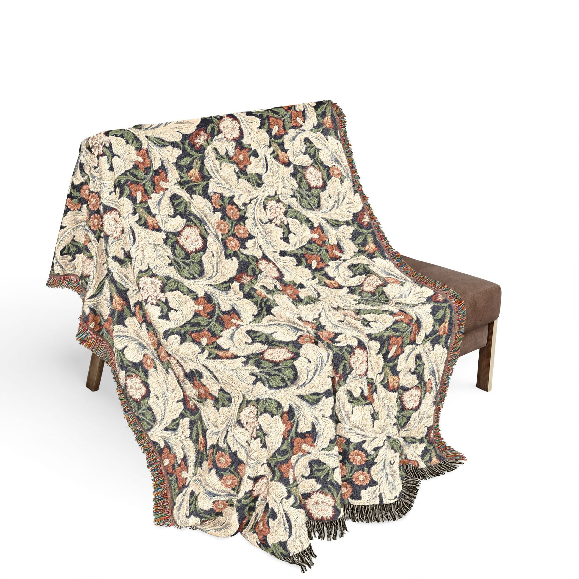 Floral patterned throw blanket draped over a chair on a white background