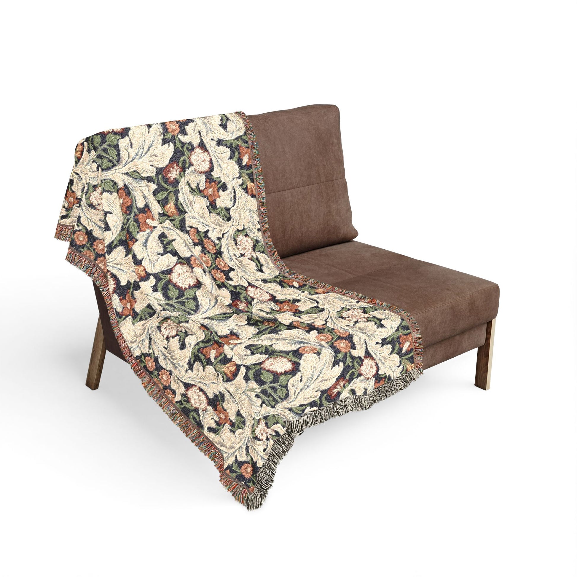 Floral-patterned throw blanket draped over a brown chair on a white background
