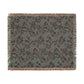 Floral patterned throw blanket with fringe on a white background