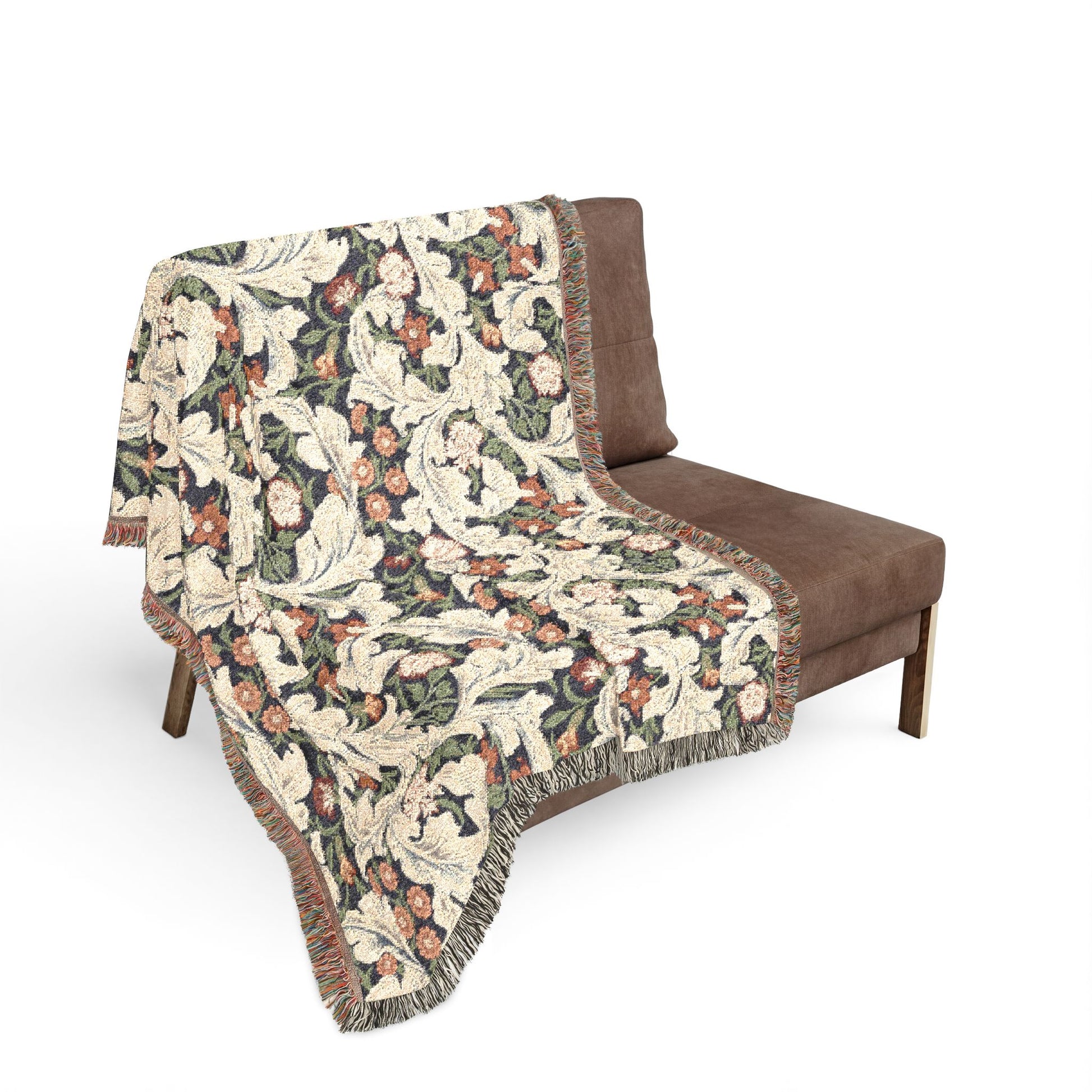 Beige patterned throw blanket draped over a brown chair on a white background