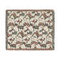 Floral patterned throw blanket with fringe on a white background