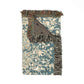 Decorative rug with floral pattern and fringed edge on a white background