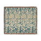 Floral patterned throw blanket with fringe on a white background
