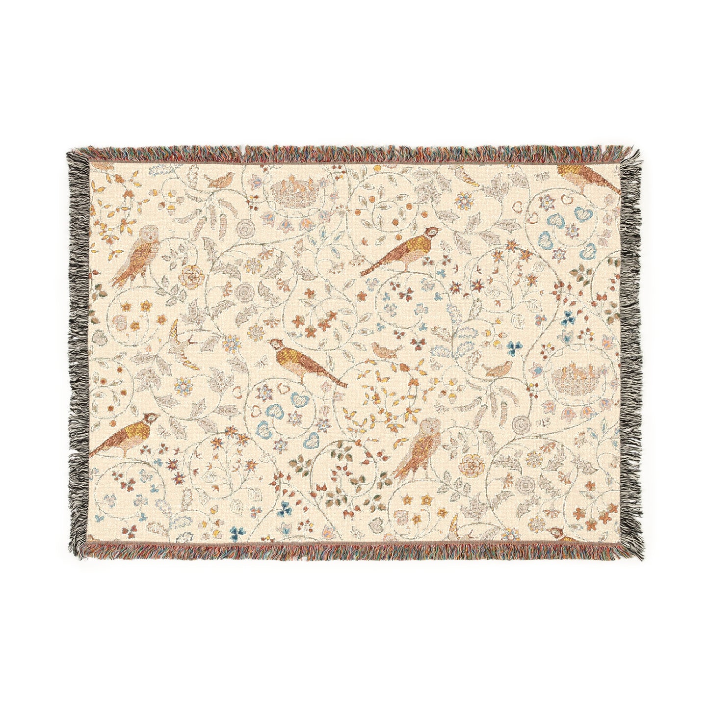 A beige woven cotton blanket with a William Morris & Co floral and bird pattern, featuring a colourful fringed edge.