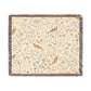 A beige woven cotton blanket with a floral and bird pattern, featuring a colorful fringed edge.