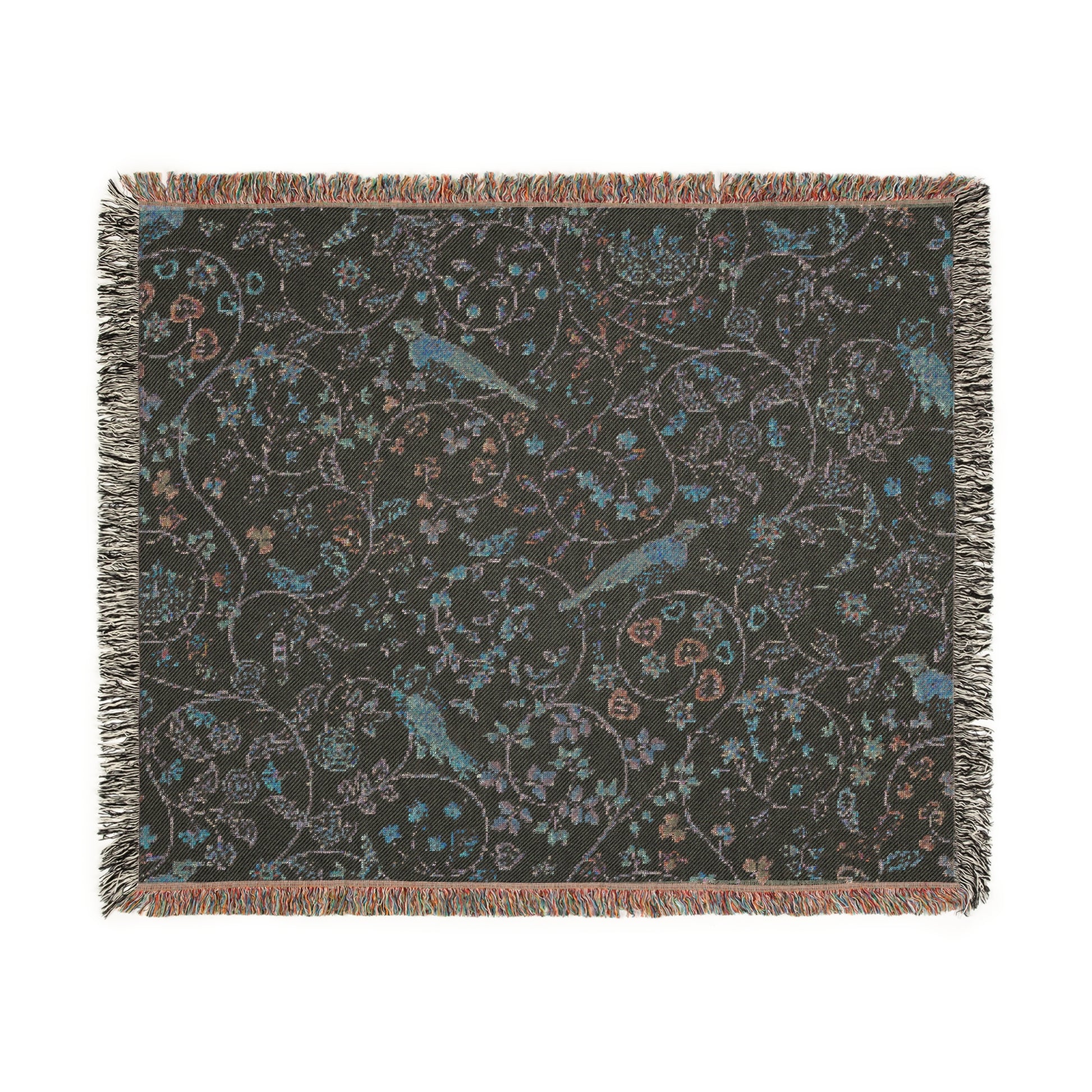 A beige woven cotton blanket with a William Morris & Co floral and bird pattern, featuring a colourful fringed edge.