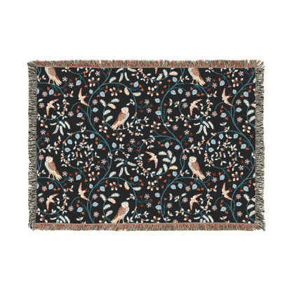 Decorative blanket with bird and floral pattern on a black background