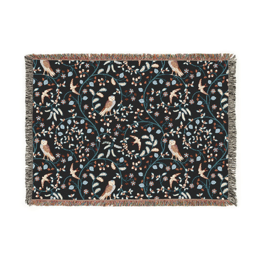 Decorative blanket with bird and floral pattern on a black background