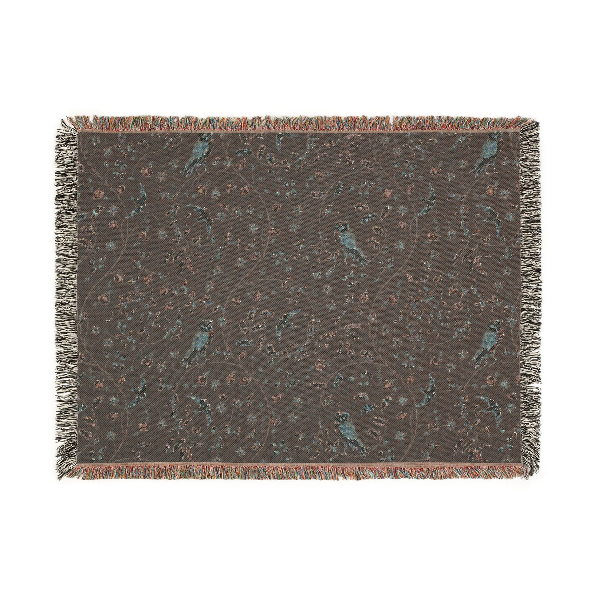 Patterned throw blanket with fringe on a white background