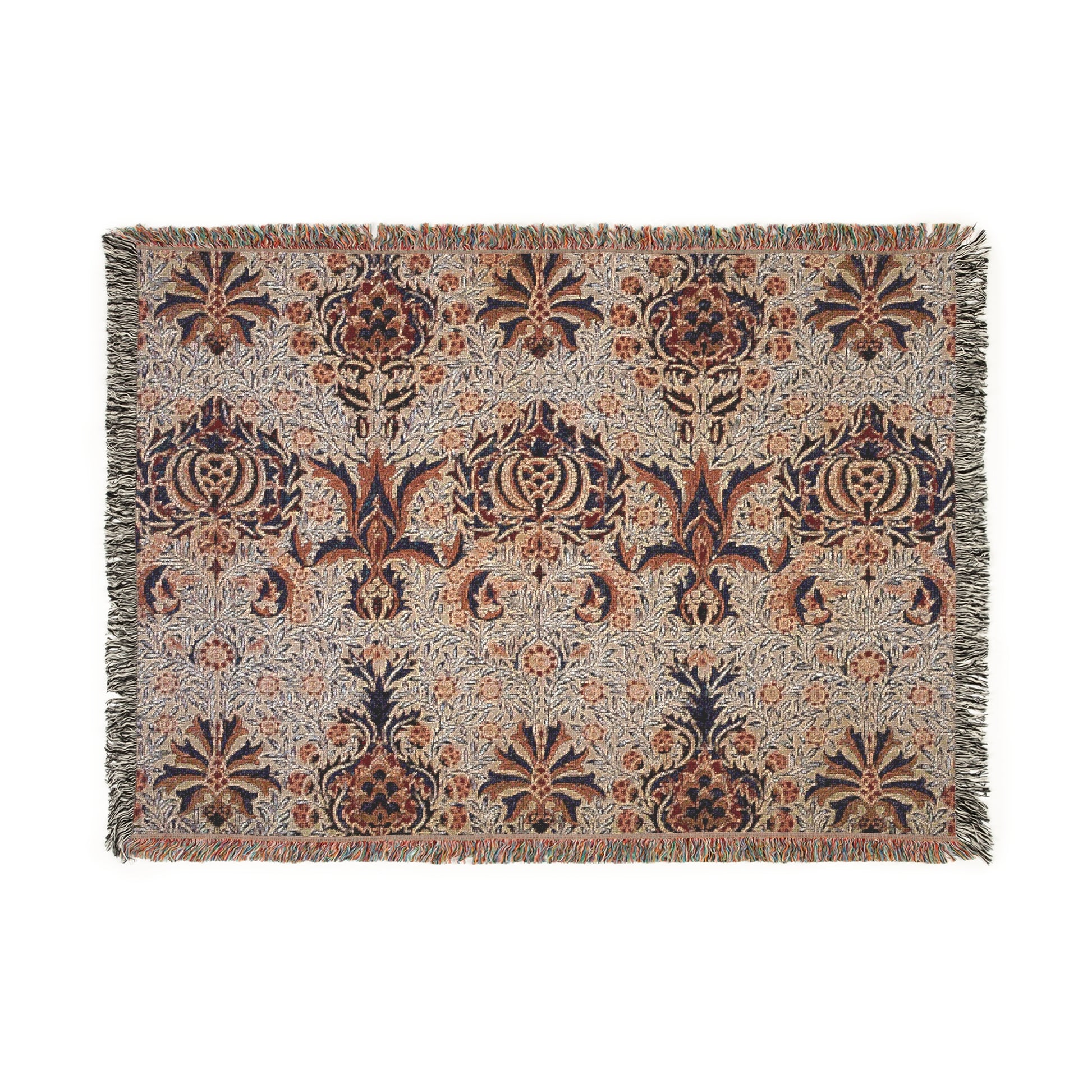 A woven cotton blanket with a geometric William Morris & Co pattern in shades of brown, beige, and black, with a colourful fringed edge.
