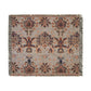 A woven cotton blanket with a geometric pattern in shades of brown, beige, and black, with a colorful fringed edge.