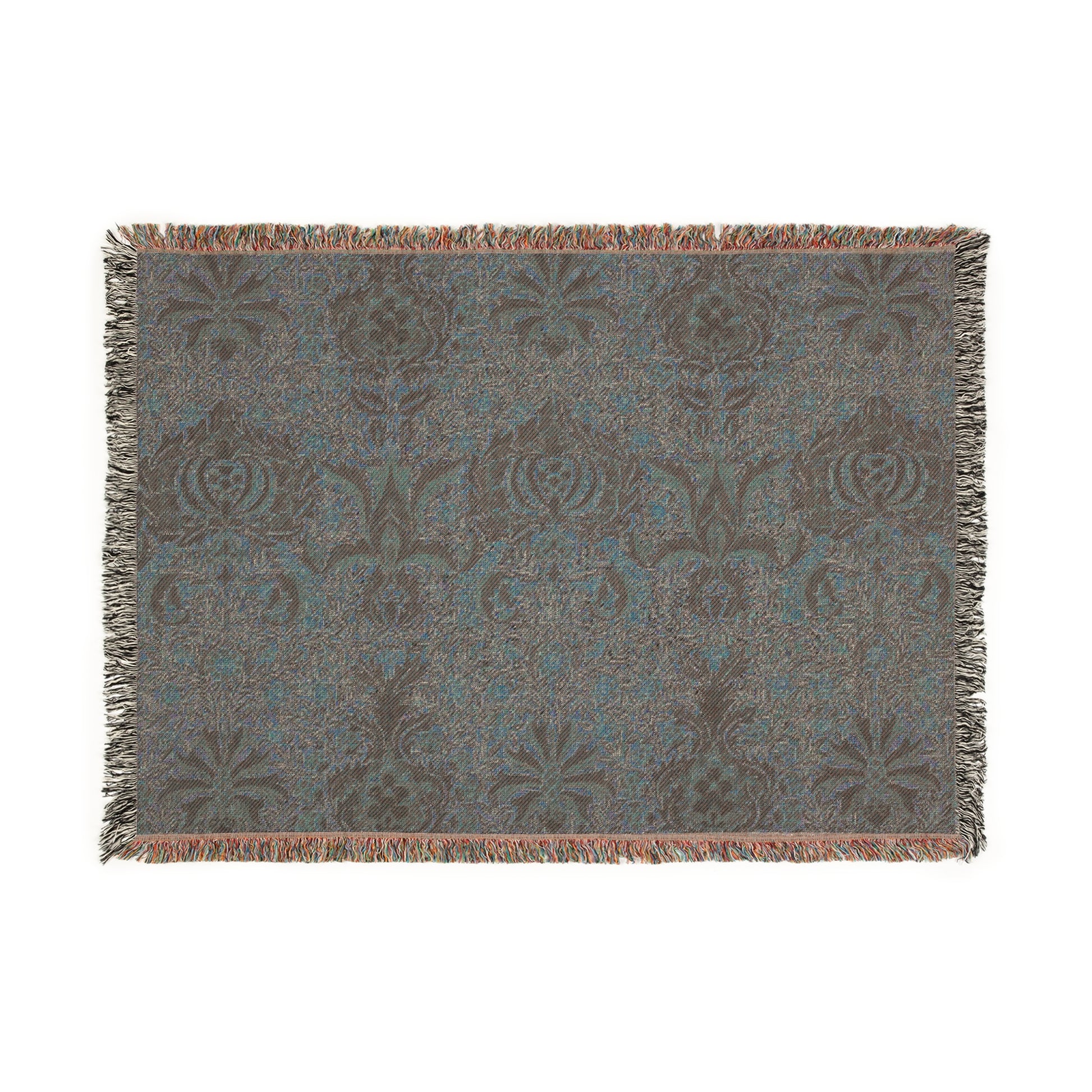 A woven cotton blanket with a geometric William Morris & Co pattern in shades of brown, beige, and black, with a colourful fringed edge.