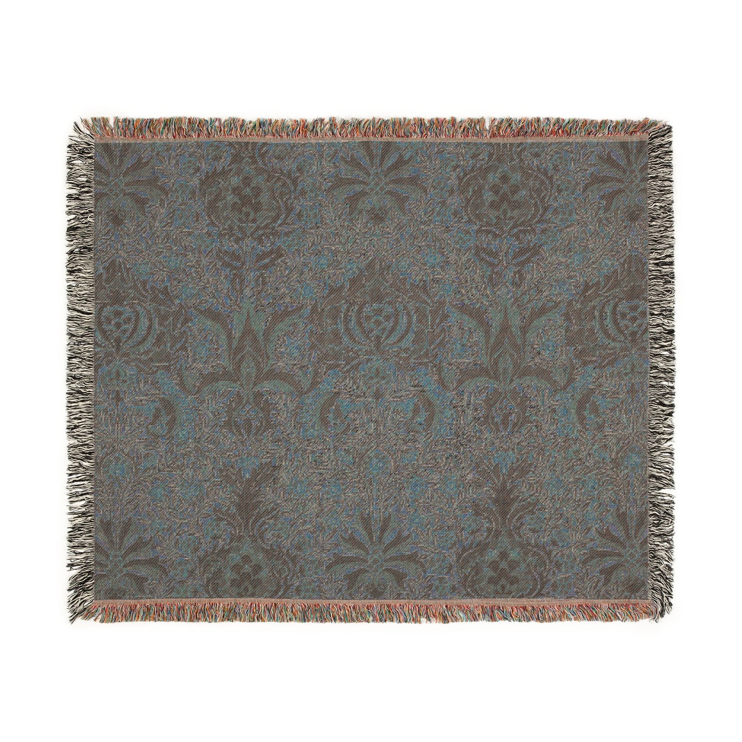 A woven cotton blanket with a geometric William Morris & Co pattern in shades of brown, beige, and black, with a colourful fringed edge.
