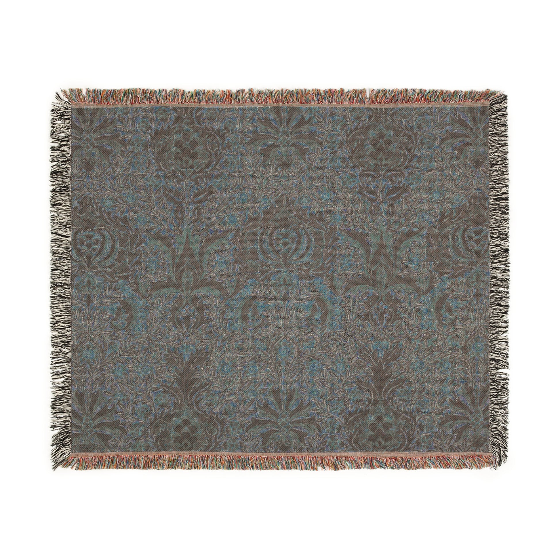 A woven cotton blanket with a geometric William Morris & Co pattern in shades of brown, beige, and black, with a colourful fringed edge.