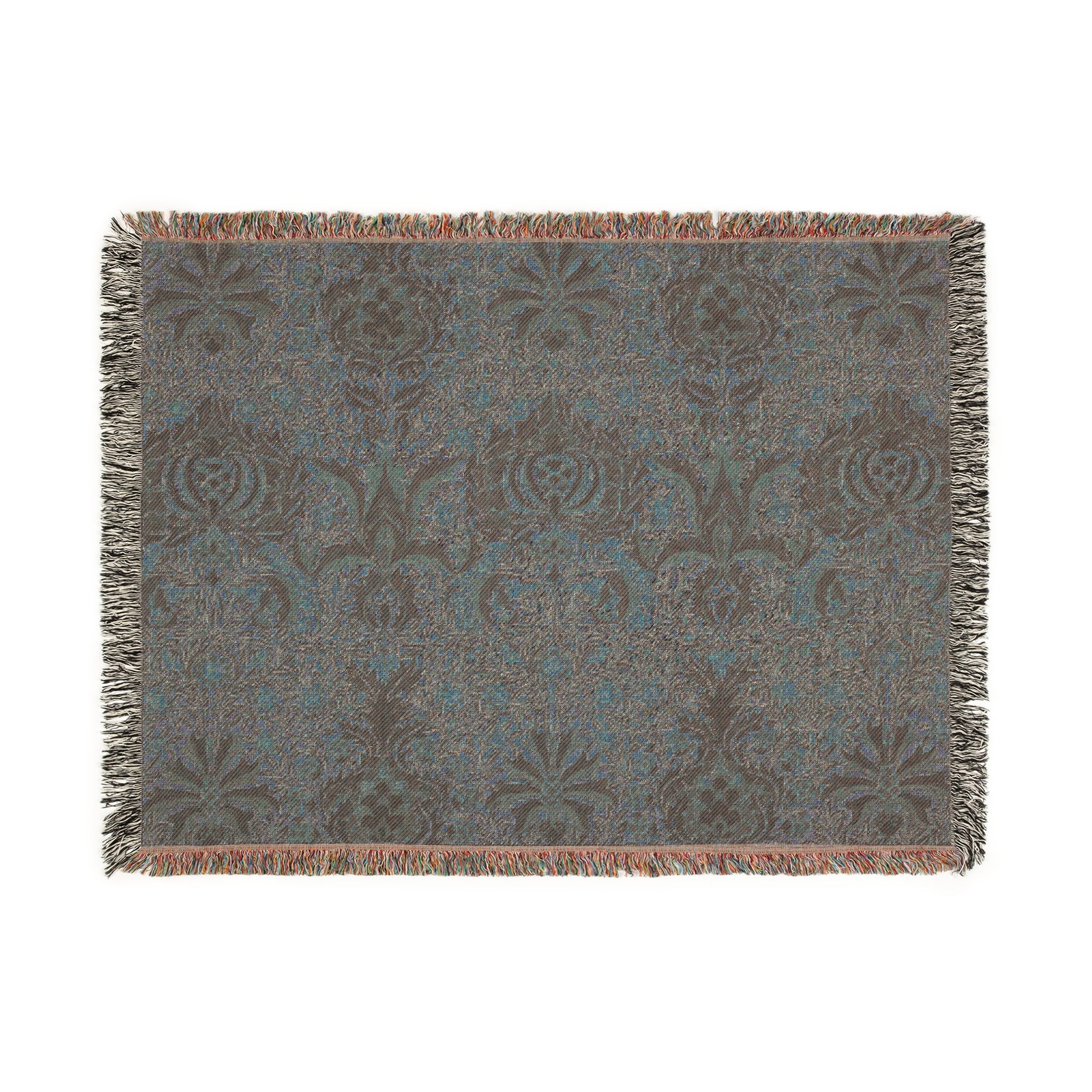A woven cotton blanket with a geometric William Morris & Co pattern in shades of brown, beige, and black, with a colourful fringed edge.