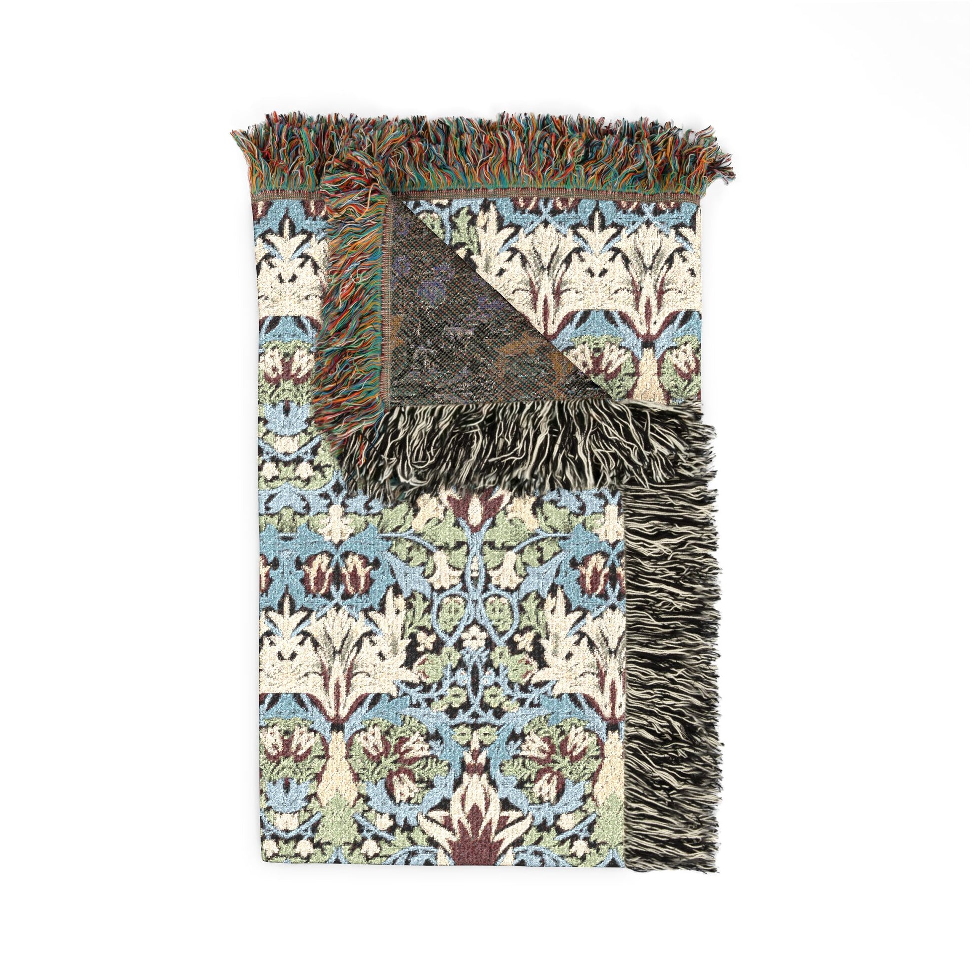 Decorative throw blanket with intricate pattern and fringes on a white background