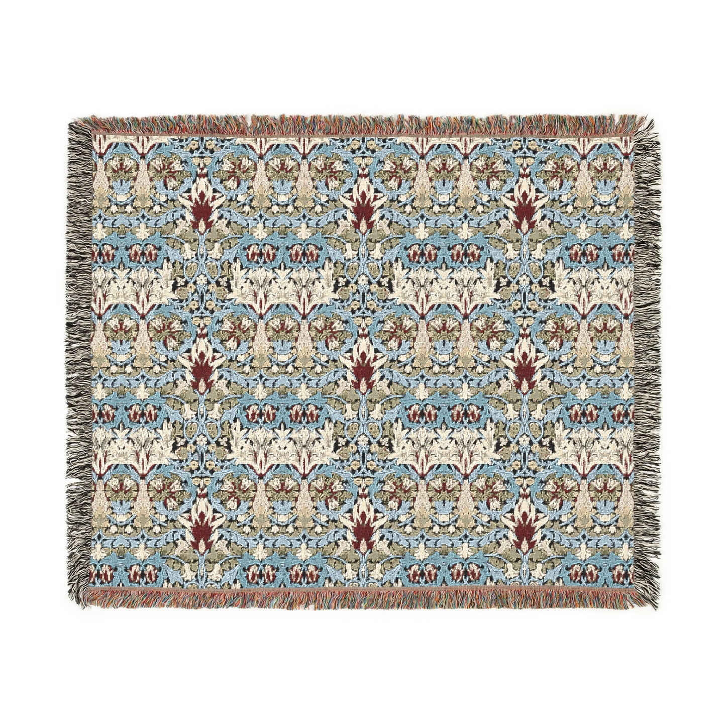 A woven blanket with a floral pattern in shades of blue, beige, and red with a fringed edge.