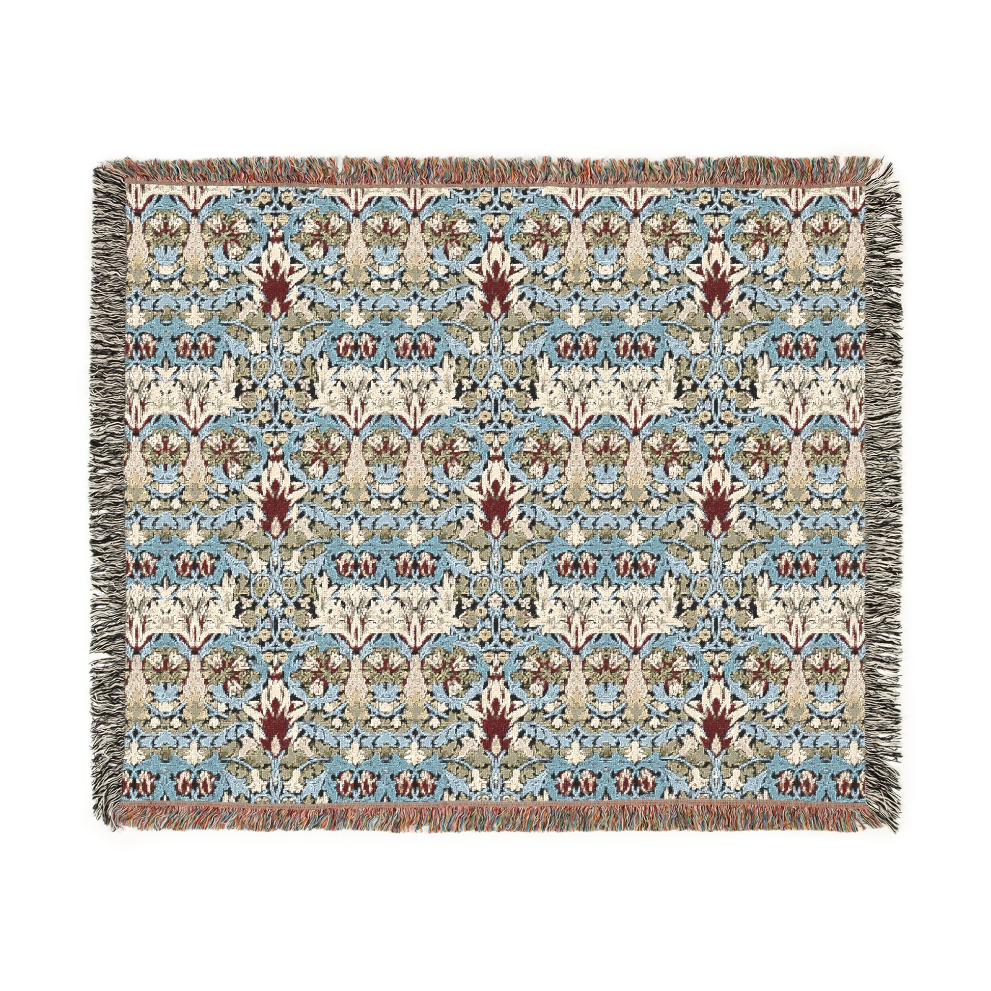 A woven blanket with a floral pattern in shades of blue, beige, and red with a fringed edge.