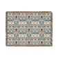 A woven blanket with a floral pattern in shades of blue, beige, and red with a fringed edge.