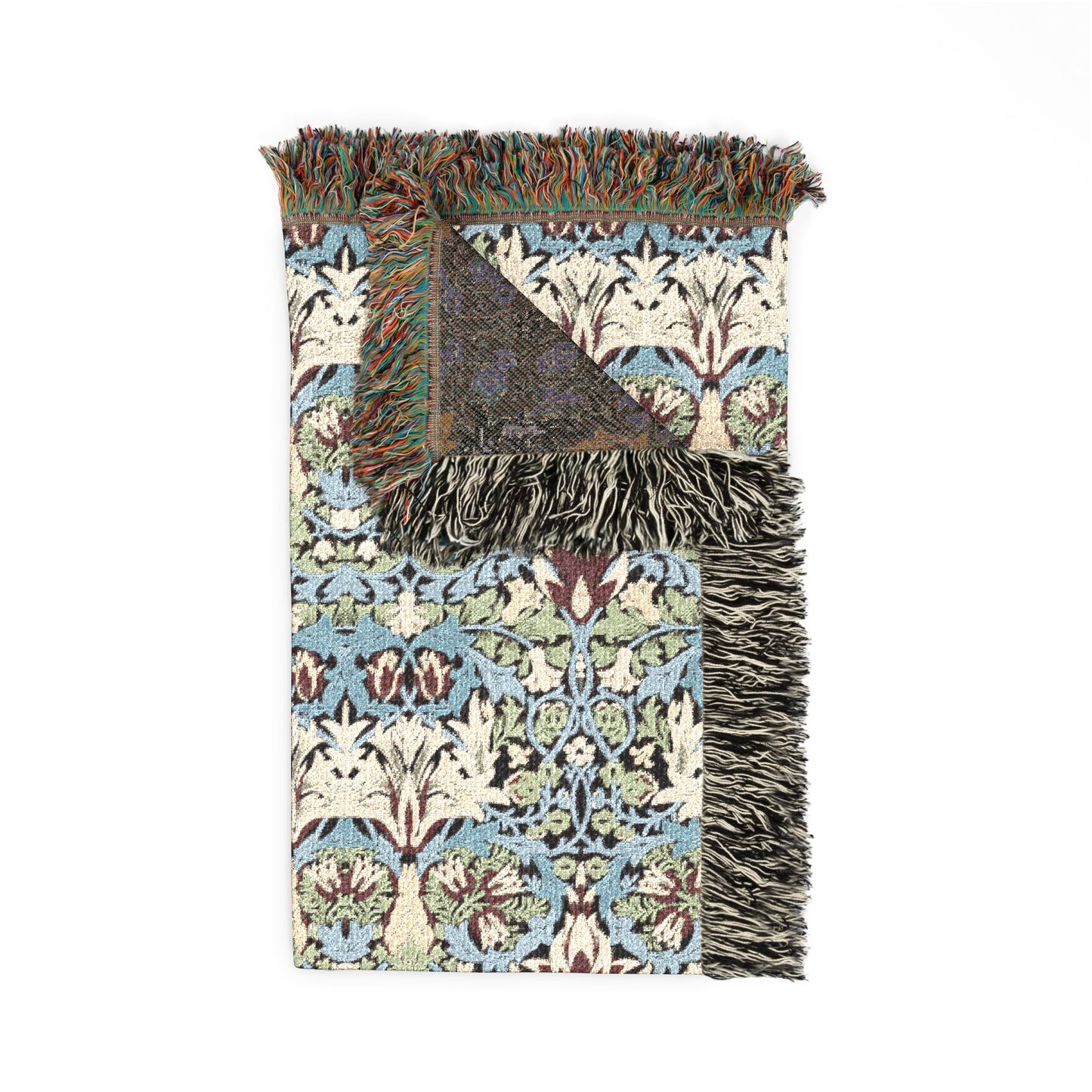 Decorative throw blanket with intricate pattern and fringes on a white background