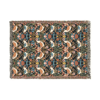 Floral and animal patterned throw blanket on a white background