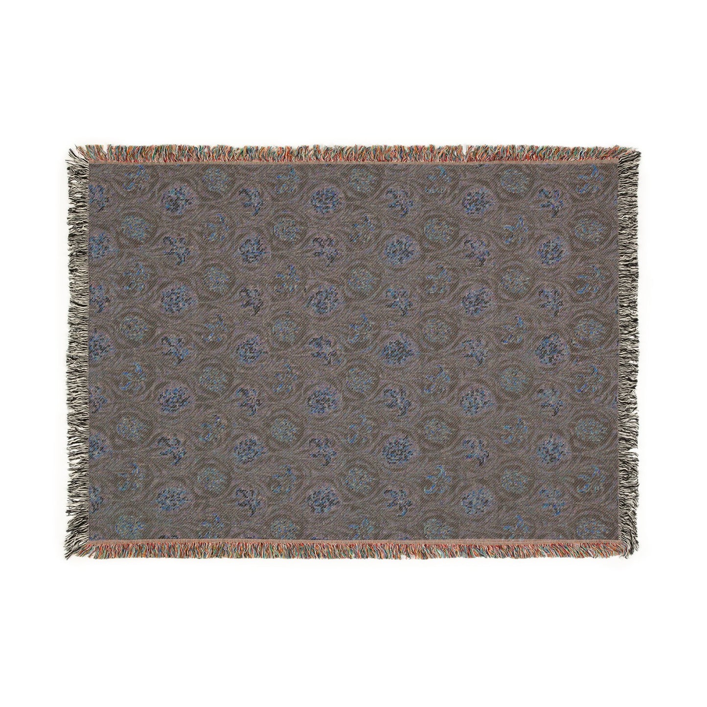Patterned throw blanket with fringe on a white background
