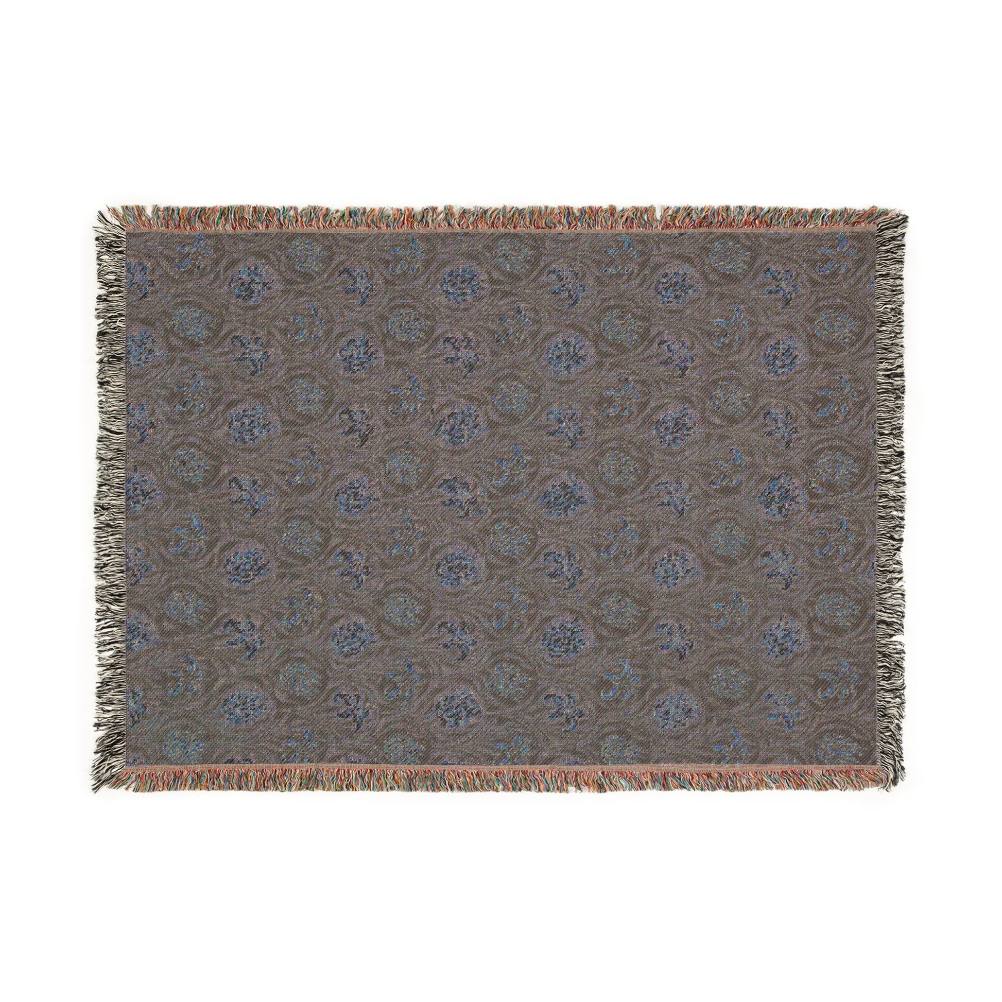 Patterned throw blanket with fringe on a white background