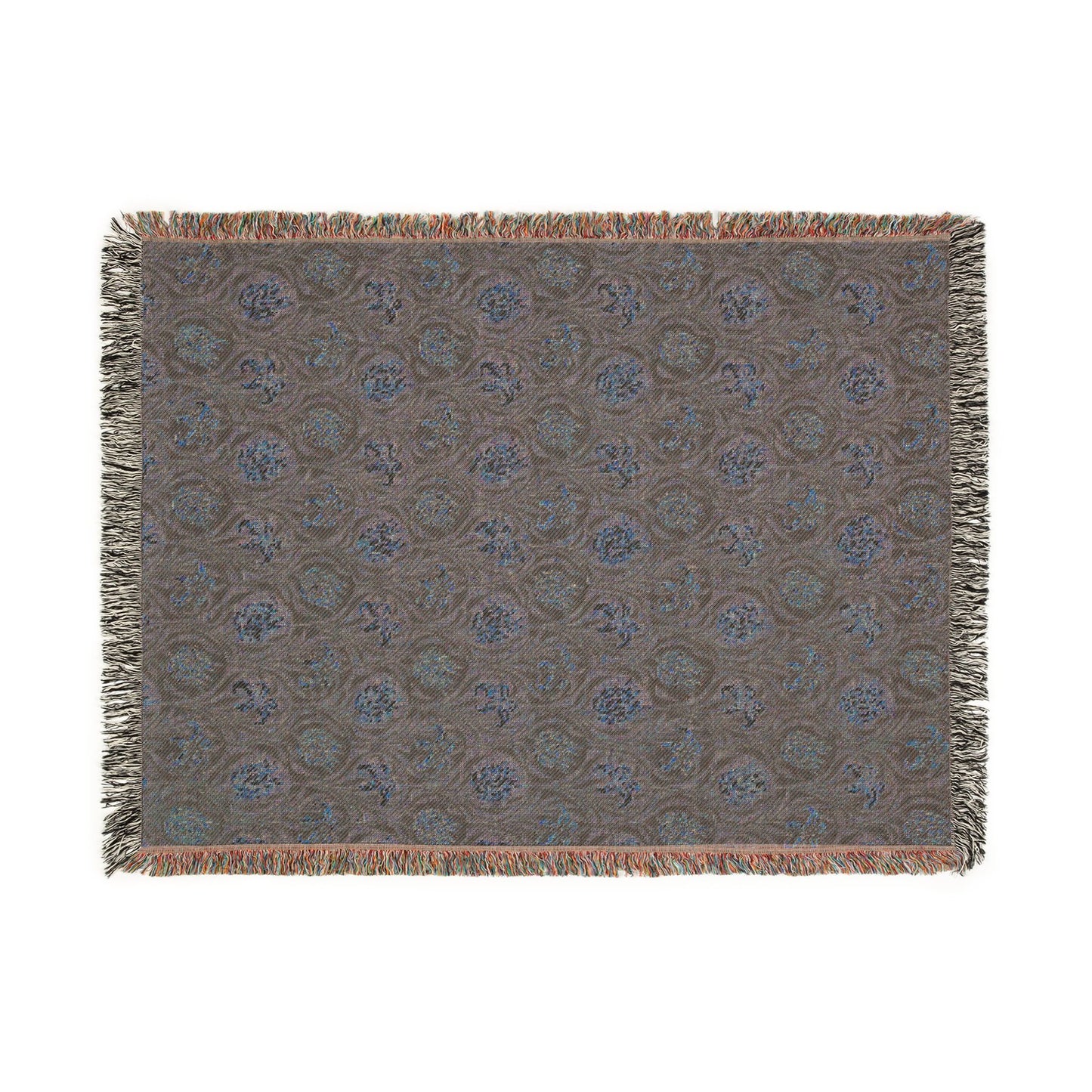 Patterned throw blanket with fringe on a white background
