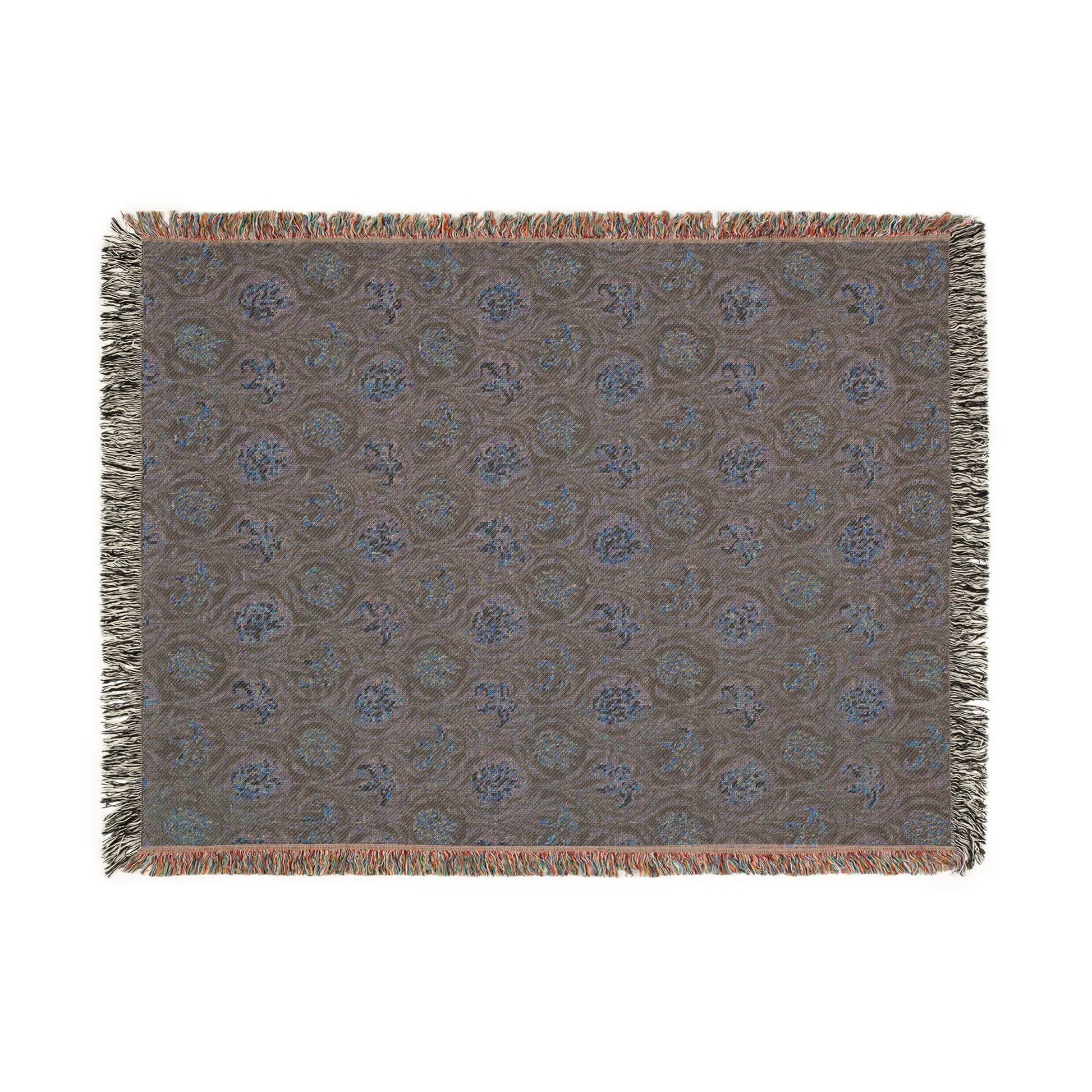 Patterned throw blanket with fringe on a white background